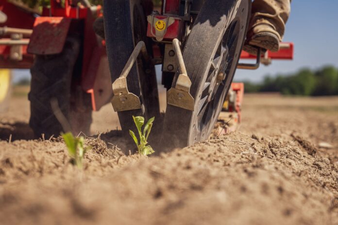 close up of tractor in field preparing soil for planting